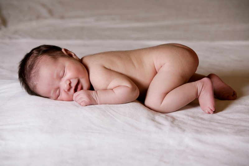 newborn baby smiling