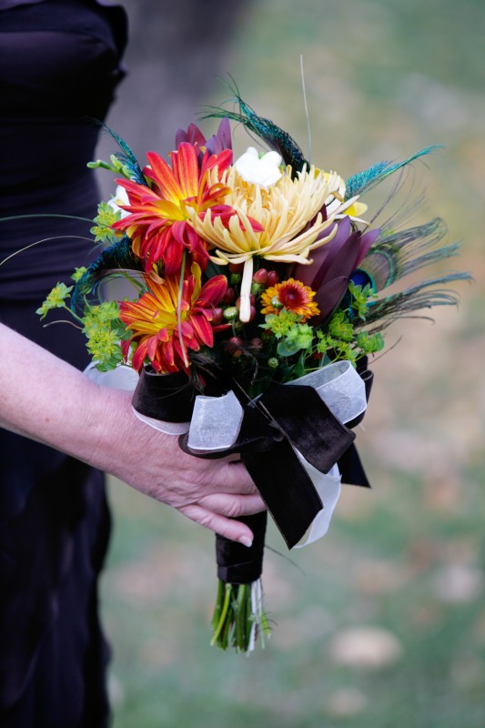 wedding flowers with orange, yellow, peacock