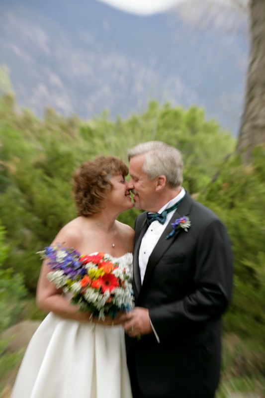 bride and groom and taos mountain