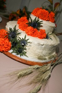 carrot cake with marigolds and wheat