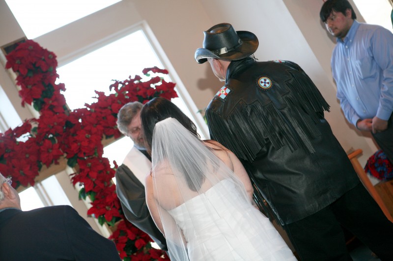 Bride, Groom, and Christmas poinsettias