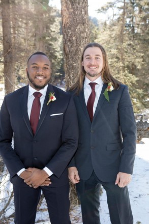 Groom and Best Man pose for photo in Carson National Forest