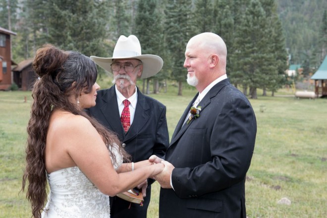 Jackie listens to Catrina say her wedding vows in the August rain in Carson National Forest