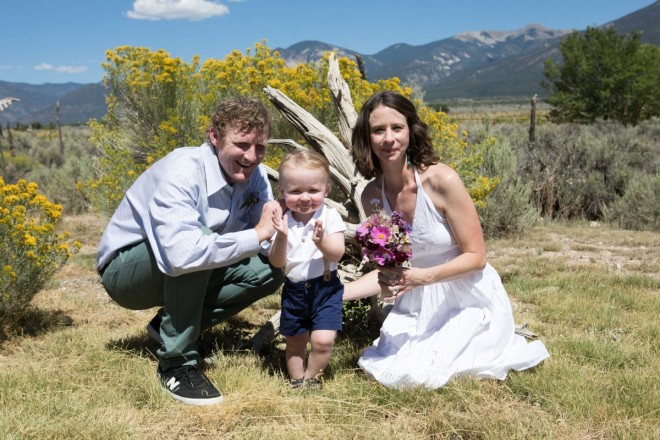 Family photo on wedding day wtih Taos mountains and spring bouquet