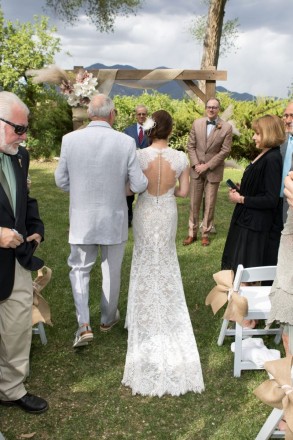 Father of the bride walks her down the aisle to the waiting groom