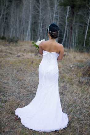Chisato stands showing the back of her wedding dress