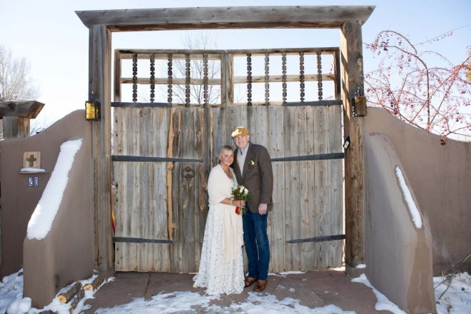 Lisa and Ian by massive doors at their Airbnb on their winter wedding day