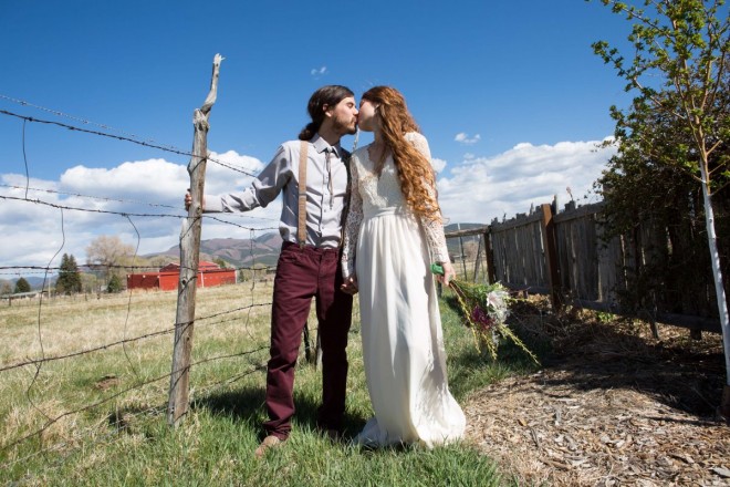 Another kiss for the hippie couple next to the wooden post barbed wire fence at SpiriTaos