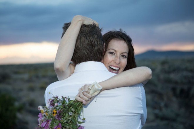 Here is Erin in a beautifully candid shot with her spring flower bouquet and new husband!!