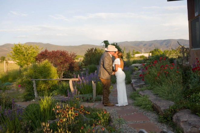 Sharing a kiss on wedding night at golden hour in Taos, NM