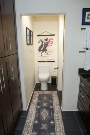 Private bathroom with dark wood cabinets in modern condo at Quail Ridge