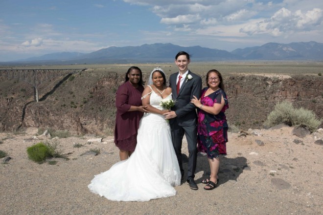 Cynthia and Dustin have a photo taken with their moms after their wedding ceremony