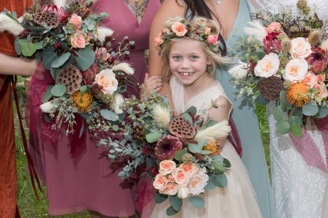 Flower girl with bouquets of professional wedding flowers