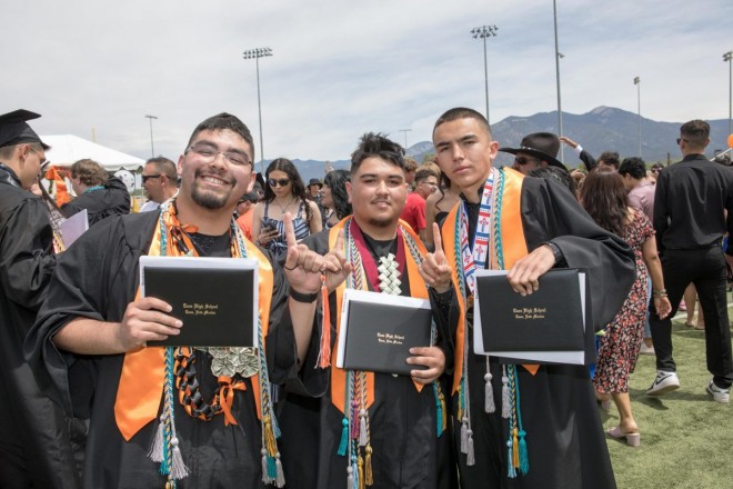 Taos high graduates show off their diplomas after graduation