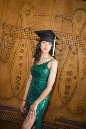 With cap and gown, Itzmir celebrates her graduation with senior photos