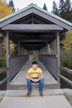 Jacob sits on the covered bridge in Red River, an icon of this little mountain town