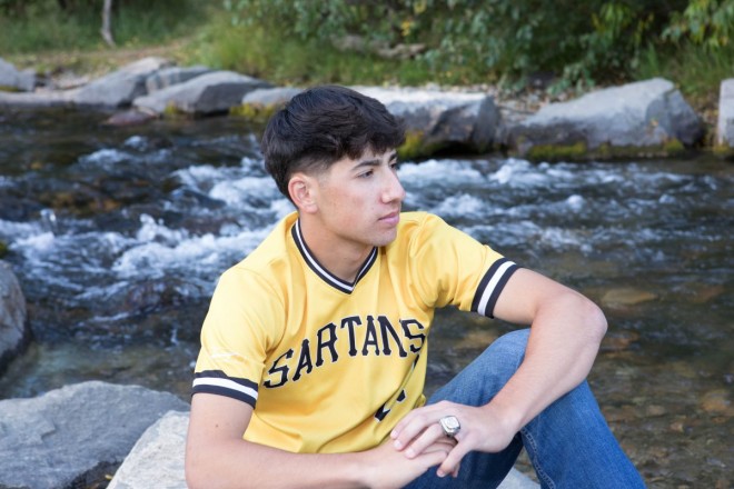Photo of Jacob with baseball jersey with river as background, in Red River, NM