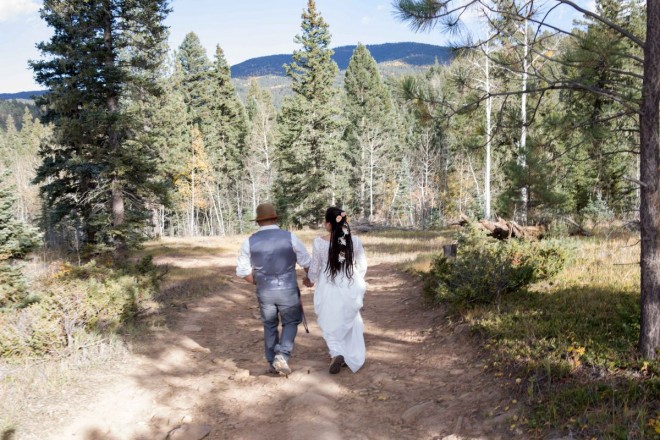 Sarah and Edwardo walk hand in hand before their Taos wedding