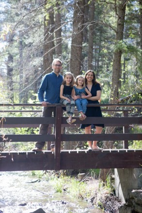 The Corner-Benjamin Family on a bridge over Taos Creek in Carson National Forest