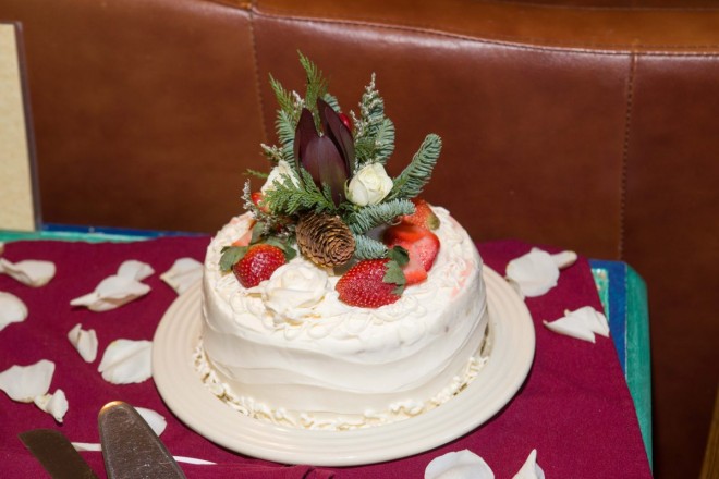 Wedding cake with wintertime decor with conifer and pinecones