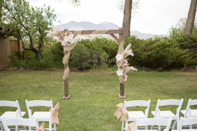 The wooden altar decorated with burlap and silk flowers