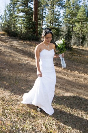 Chisato walks down the natural dirt trail to her forest wedding in Taos