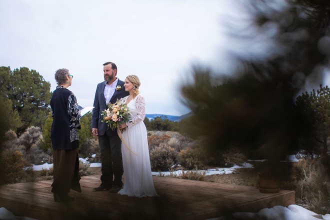 Surrounded by mountains in northern New Mexico. Linsey and Nathan listen to Sajit's wedding ceremony