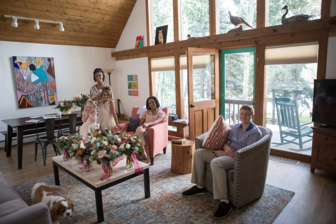 The wedding bouquets, flower girls, and good friends wait inside the lake house