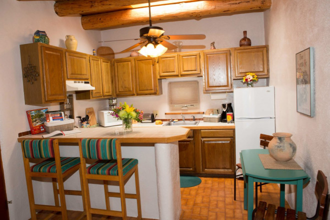 Breakfast bar with Mexican tile and turquoise accents in Taos apartment