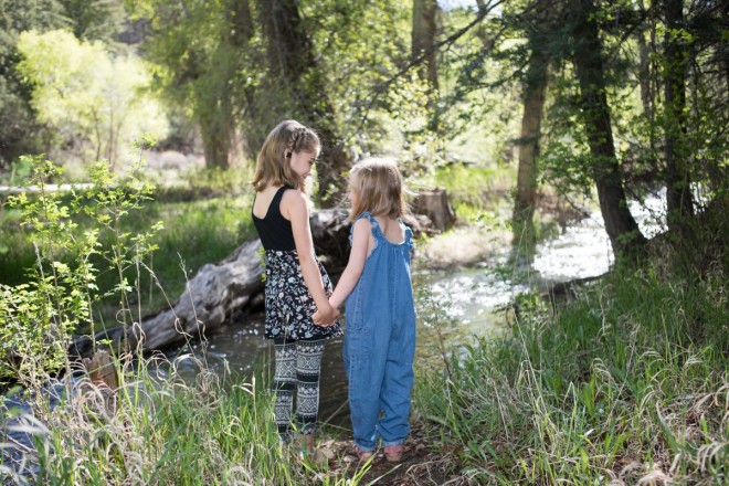 Sisters playing by the Taos Creek in Taos Canyon