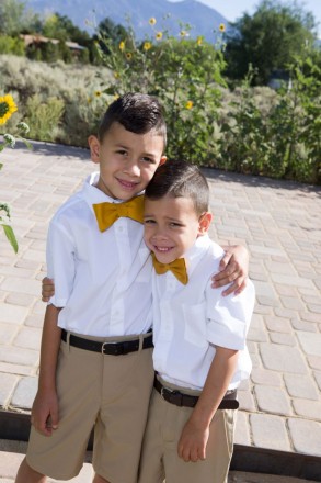 Boys in white oxford shirts and gold bowties