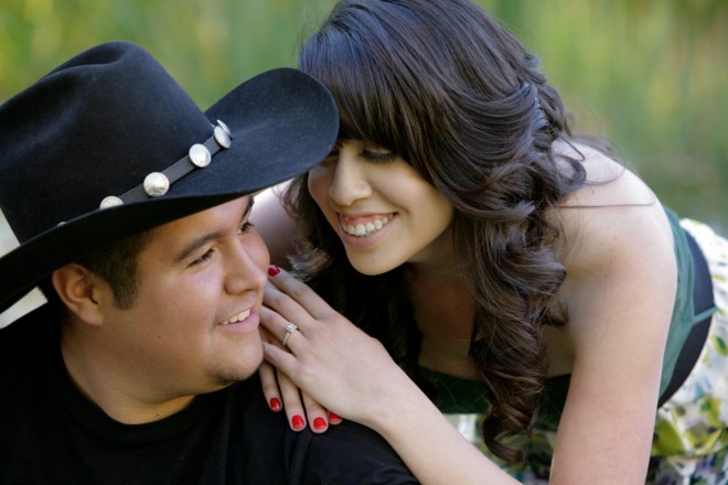 Engagement shoot with cowboy hat and red fingernails