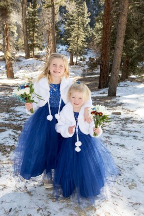 Young girls in blue flower girl dresses before wedding ceremony in Red River