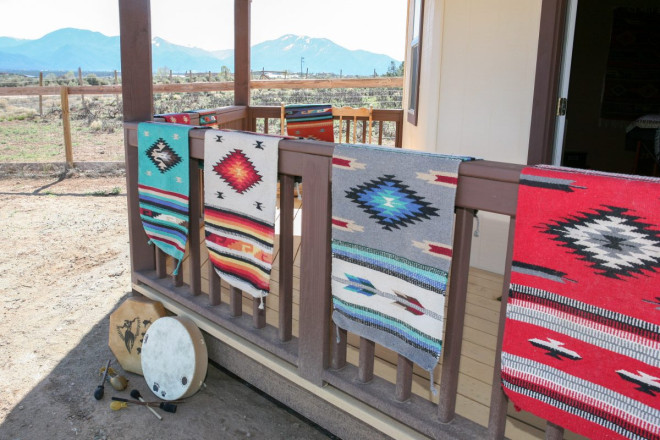 Navajo rugs hanging outside healing studio in Arroyo Hondo, NM