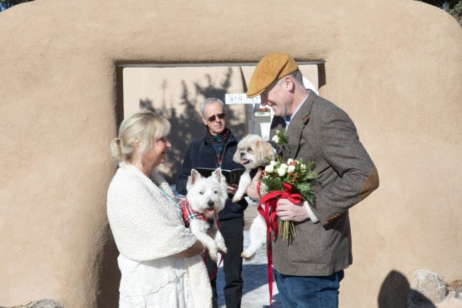 Lisa and Ian with their two dogs at their outdoor wedding ceremony in Ranchos de Taos plaza
