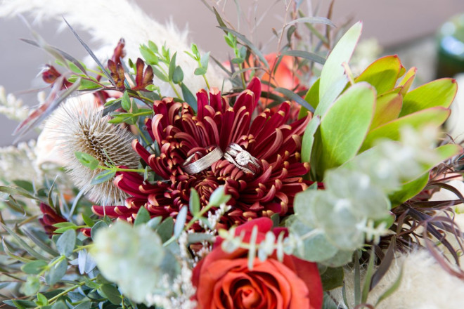 Celeste and Joe's wedding rings with the wedding bouquet