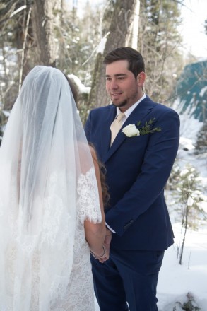 Andrew holds Kiersten's hands during their outdoor wedding at the Taos Ski Valley