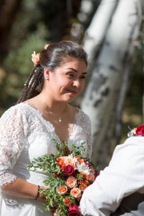 The October light touches Sarah's face during the wedding ceremony