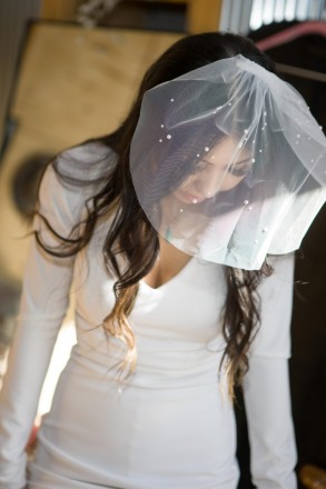 Bride with short wedding veil before her Angel Fire wedding