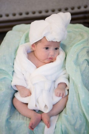 Baby Tiana poses in a towel and bathrobe for her portrait