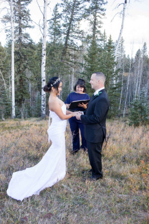 Chisato and Matthew share a smile during their outdoor October wedding ceremony