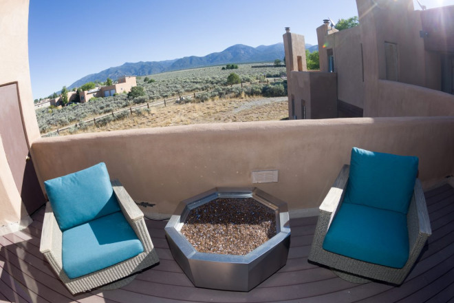 Outdoor porch with turquoise chairs and southwest style home