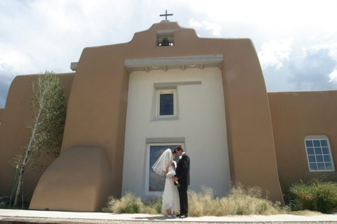 Outdoor capture of bride and groom on wedding day at St. James Episcopal Church in Taos