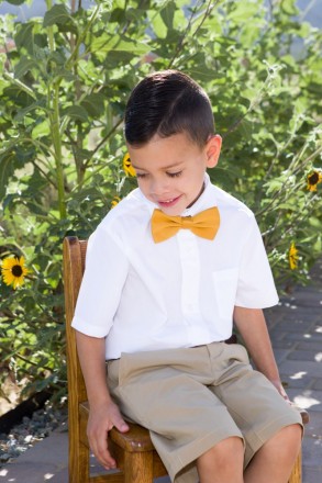 Candid picture of young New Mexico boy with gold bowtie