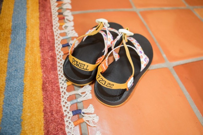 Scarlet's wedding shoes, Chacos, are embroidered with her name and date.
