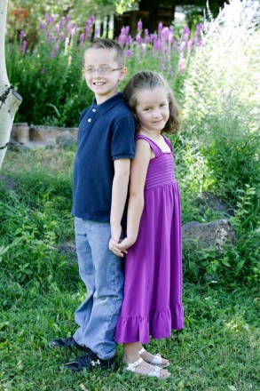 Summertime childrens pictures of siblings with purple dress and purple flowers