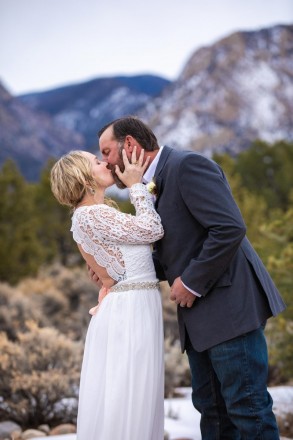 The mountains look behind as Linsey and Nathan seal their wedding vows with a kiss