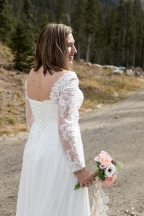 Bride eloping to Taos Ski Valley from Texas, professional bouquet and dress with lace sleeves