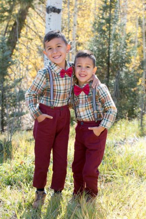 Brothers in suspenders pose for an autumn portrait