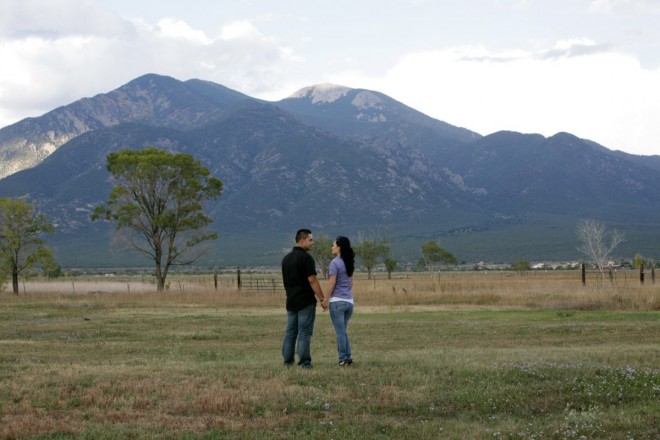 Newly engaged couple with Taos mountain